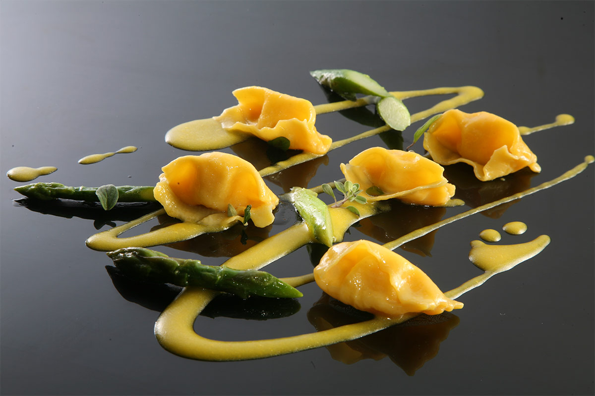 Ravioli con sfoglia all'uovo, asparagi, crema allo zafferano e maggiorana Ravioli con sfoglia all'uovo, asparagi, crema allo zafferano e maggiorana